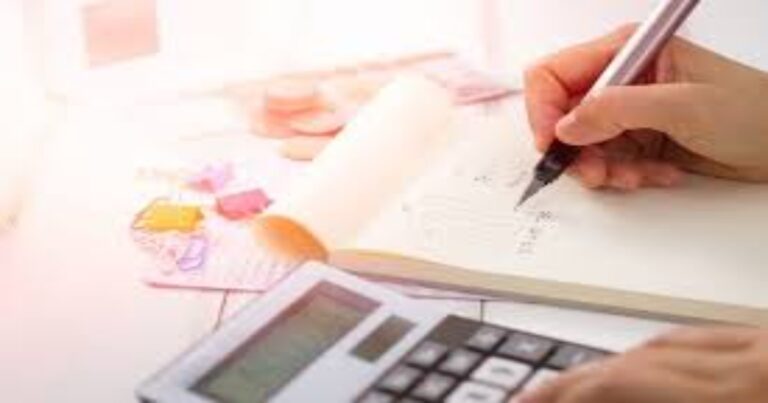 writing on a notepad and using calculator