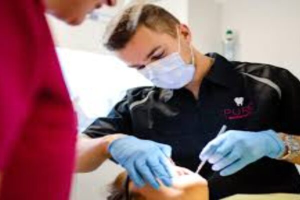 A dentist examining a patient's teeth