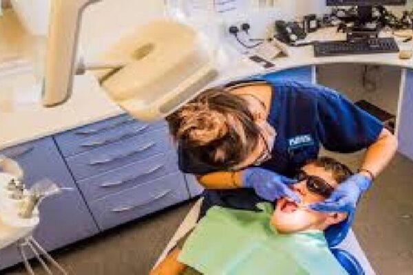 A dentist examining patient's teeth