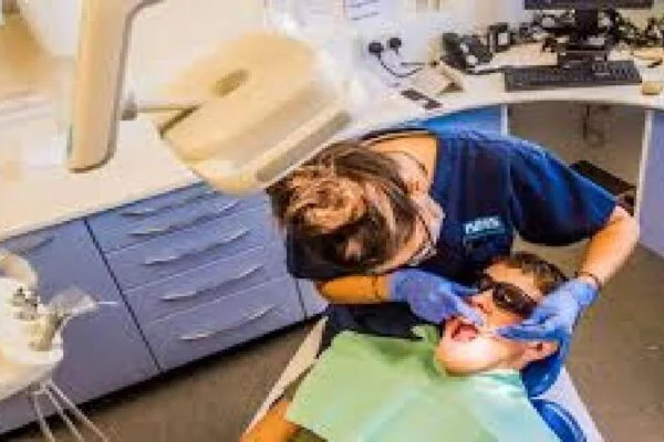A dentist examining patient's teeth